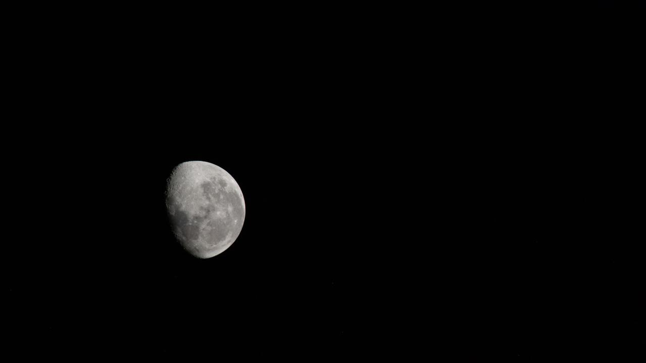 The cratered Moon against the blackness of space.