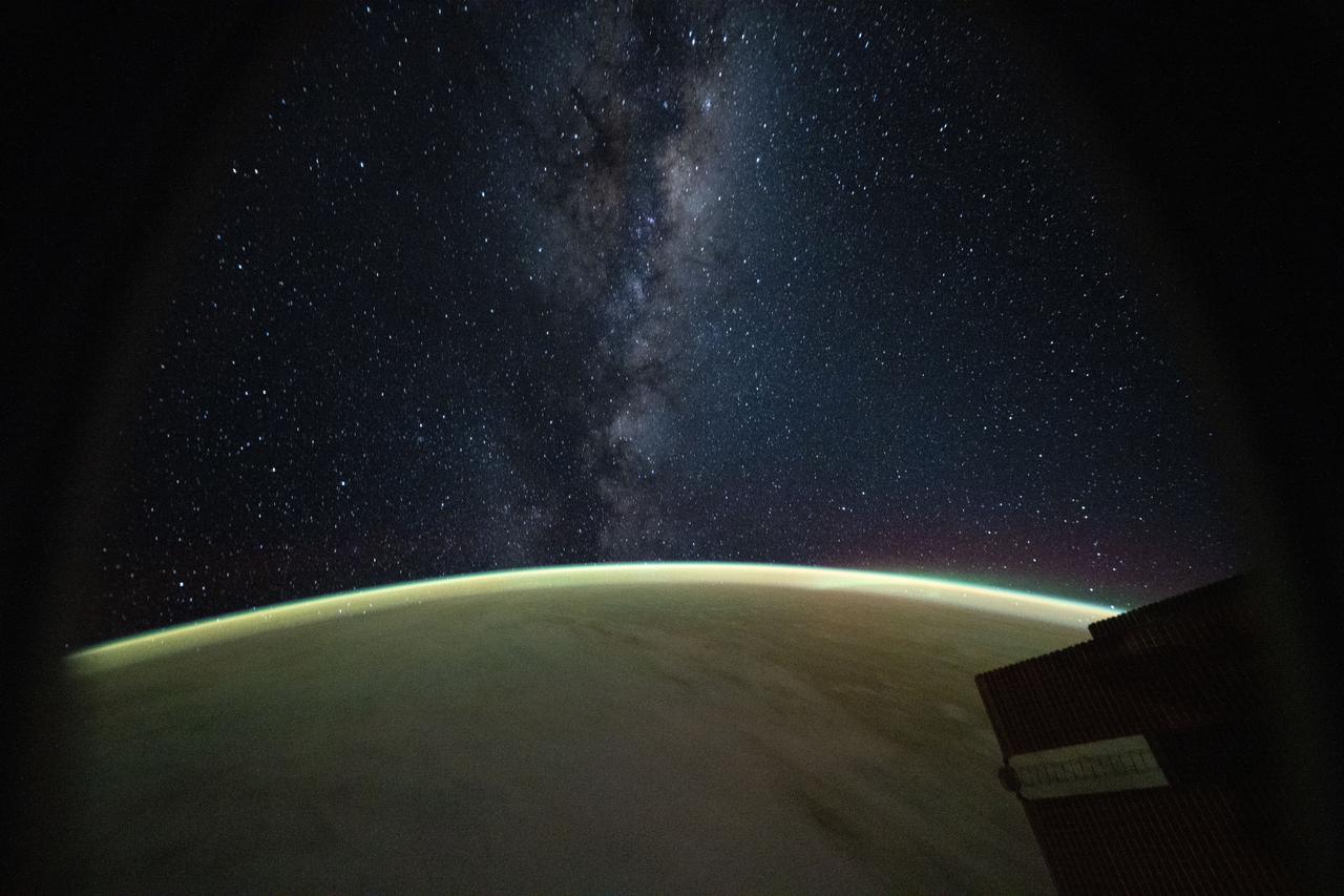 The Milky Way above Earth’s glowing horizon.